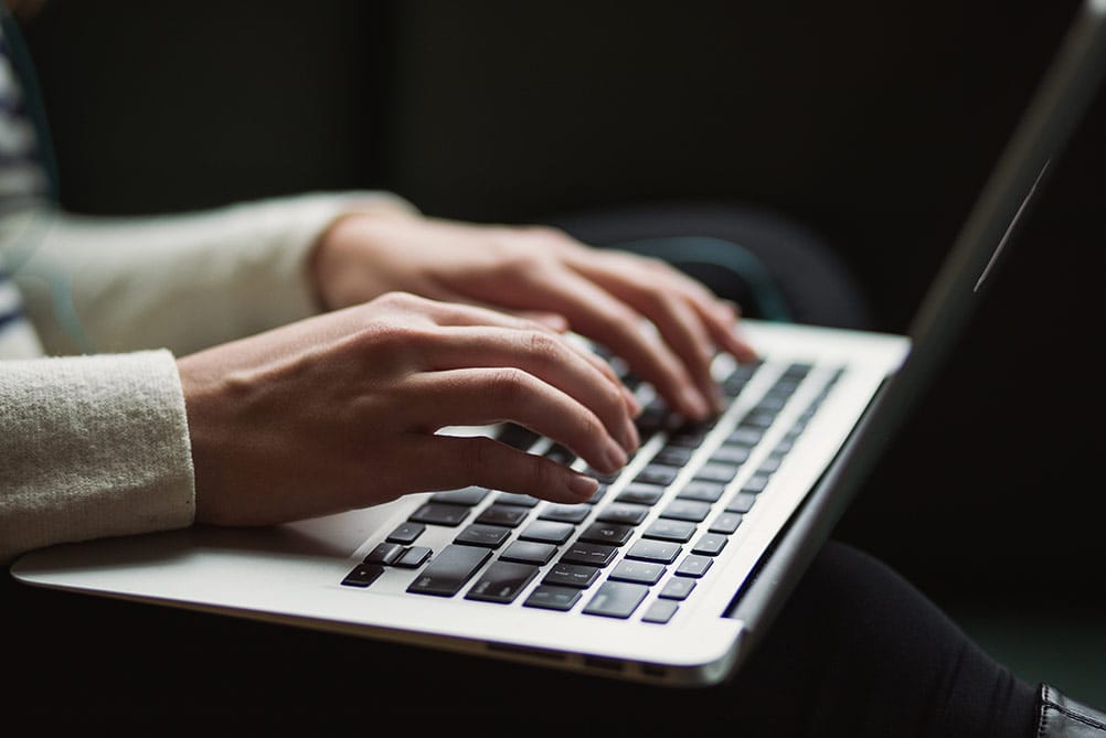 typing on a laptop for seo